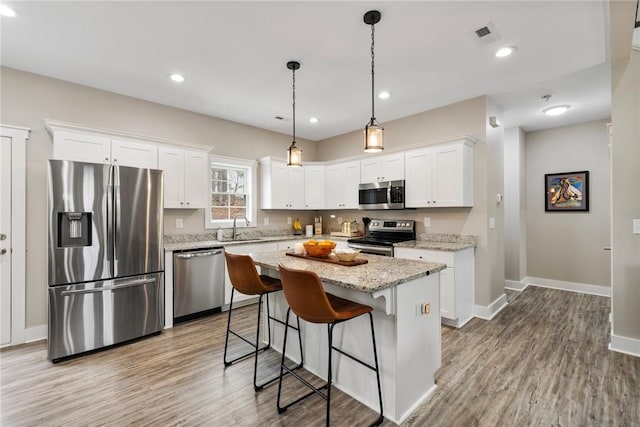 103 W Chestnut Cir, Central, SC 29630 - kitchen with appliances with stainless steel finishes, white cabinets, light wood-style floors, and recessed lighting