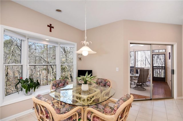 dining space featuring light tile patterned floors and baseboards