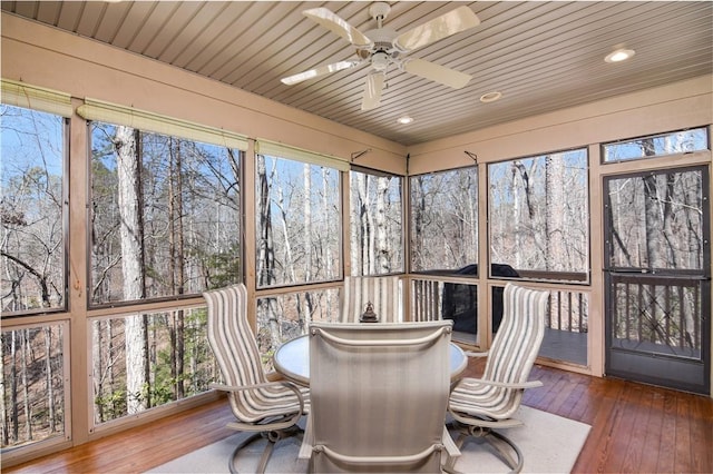 sunroom with wooden ceiling and ceiling fan