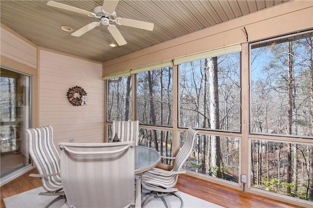 sunroom featuring wooden ceiling and a ceiling fan