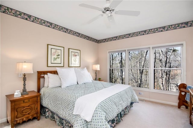 bedroom with baseboards, multiple windows, carpet, and ceiling fan