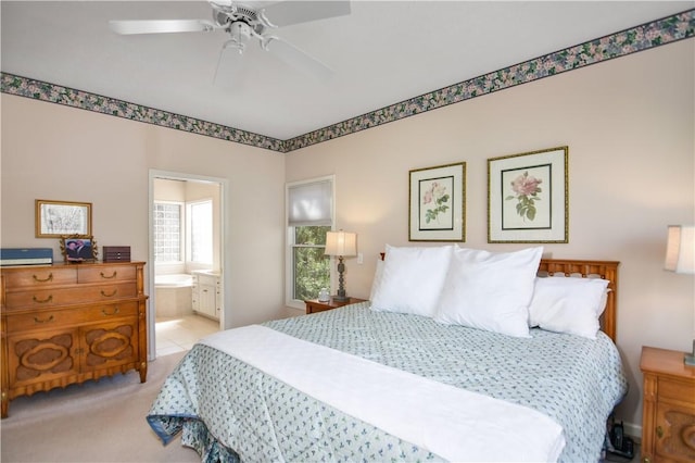 bedroom featuring ensuite bath and a ceiling fan