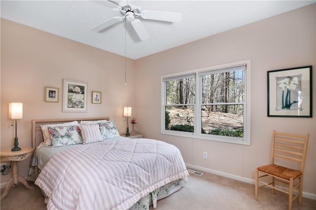 bedroom featuring visible vents, baseboards, carpet, and ceiling fan