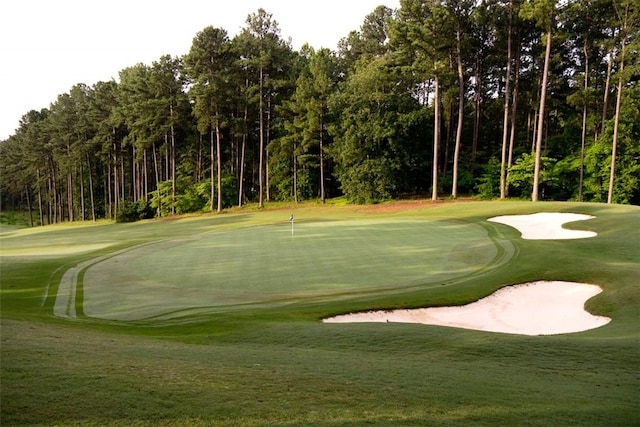 view of home's community with a yard and view of golf course