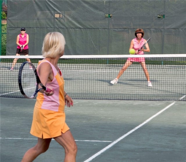 view of tennis court with fence