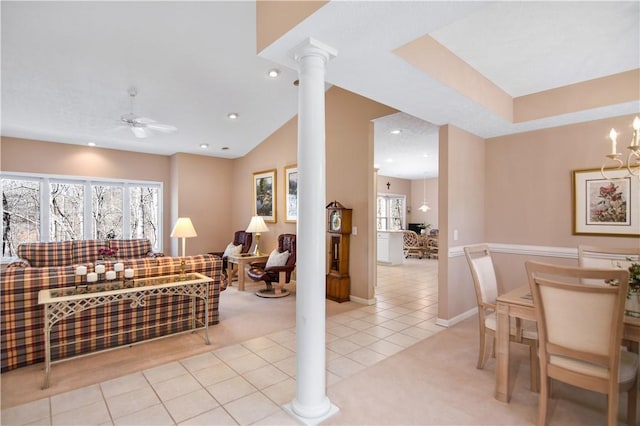 carpeted living room featuring tile patterned floors, recessed lighting, a healthy amount of sunlight, and ornate columns