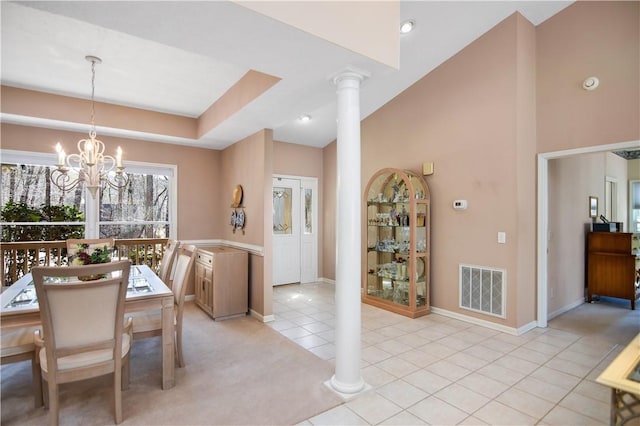 dining room featuring light tile patterned floors, visible vents, high vaulted ceiling, an inviting chandelier, and decorative columns