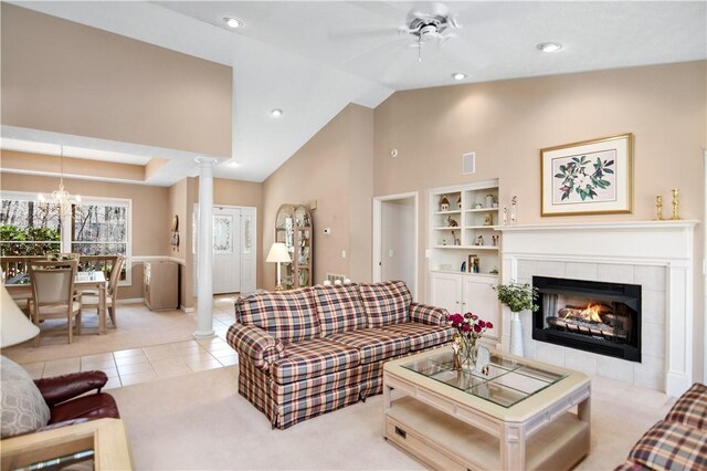 living area with visible vents, decorative columns, light tile patterned floors, recessed lighting, and a tile fireplace