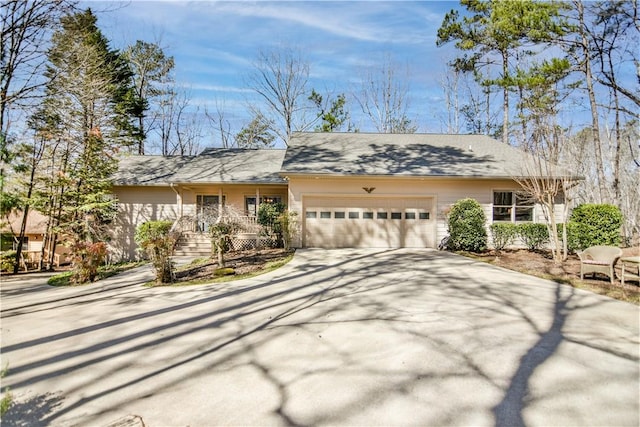 ranch-style house featuring an attached garage and concrete driveway