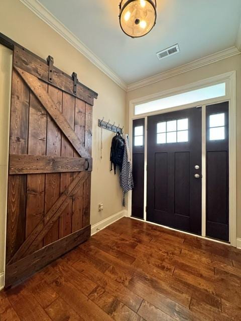 entryway featuring dark wood-type flooring, plenty of natural light, visible vents, and ornamental molding