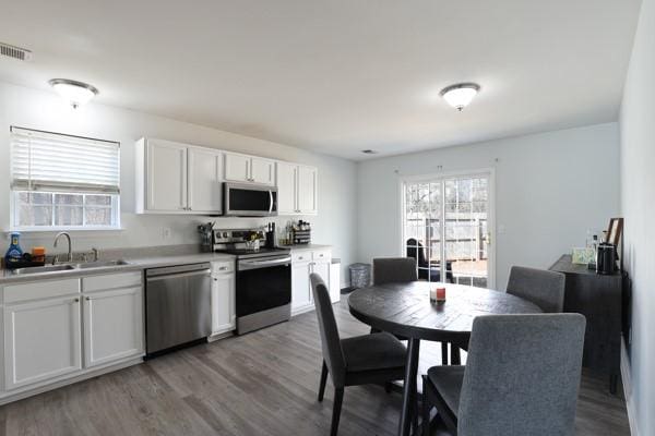 kitchen with light wood-style flooring, plenty of natural light, visible vents, and stainless steel appliances