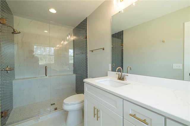 bathroom with a shower stall, toilet, recessed lighting, tile patterned floors, and vanity