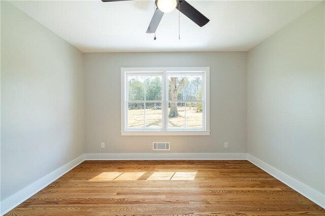 unfurnished room featuring visible vents, baseboards, light wood-style floors, and a ceiling fan