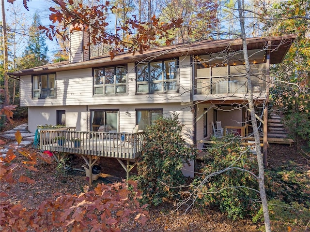 back of property featuring stucco siding and a chimney