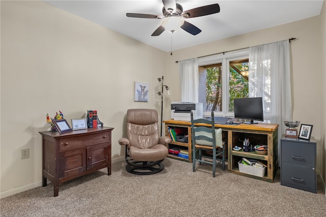 home office featuring carpet flooring, a ceiling fan, and baseboards