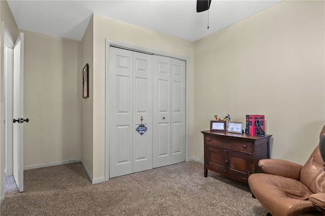 living area with baseboards and carpet floors