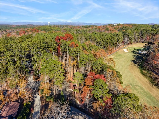 drone / aerial view featuring a view of trees and a mountain view