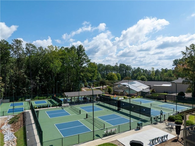 view of tennis court featuring fence