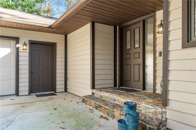 view of exterior entry with a porch