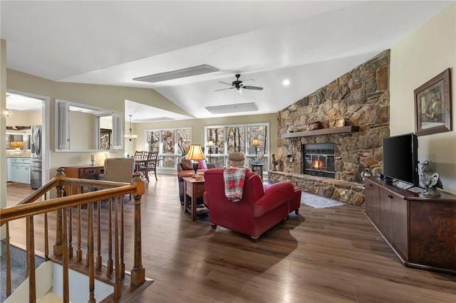 living room with ceiling fan, a fireplace, lofted ceiling, and wood finished floors