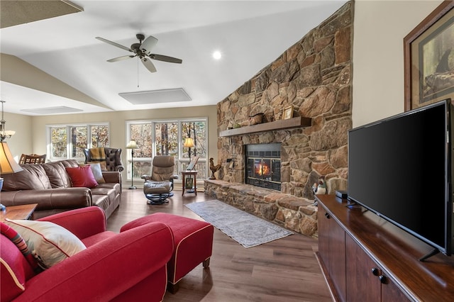 living area with a fireplace, wood finished floors, a ceiling fan, and vaulted ceiling