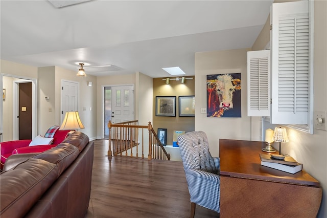 living room with a skylight and wood finished floors