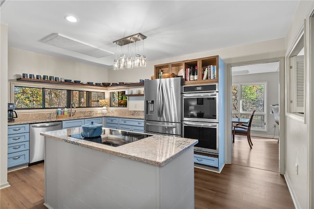 kitchen with open shelves, light stone counters, a kitchen island, stainless steel appliances, and dark wood-style flooring