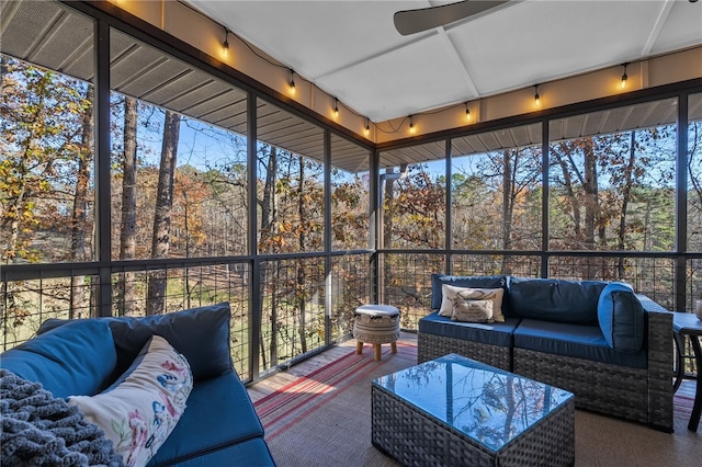 sunroom featuring a healthy amount of sunlight and a ceiling fan