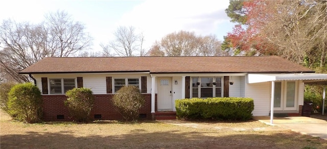 single story home with an attached carport, roof with shingles, and crawl space