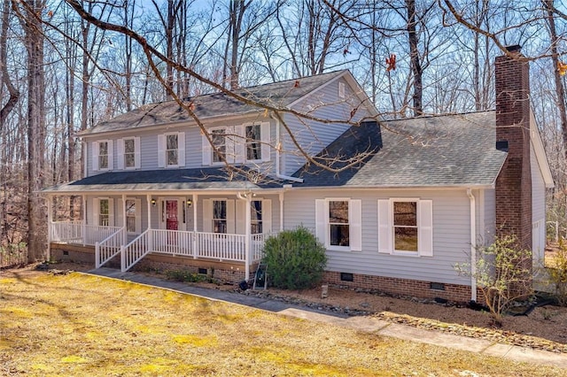 view of front of home with a front lawn, a porch, roof with shingles, crawl space, and a chimney