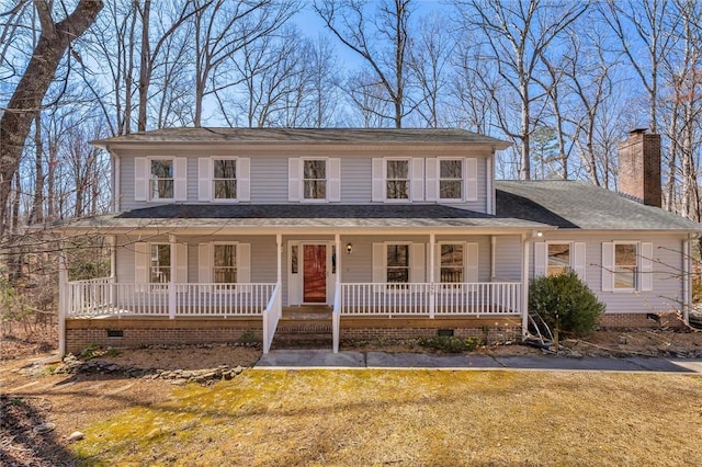 view of front facade with a front lawn, a chimney, covered porch, and crawl space