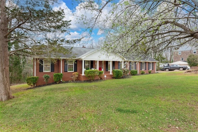 single story home with a front yard and brick siding