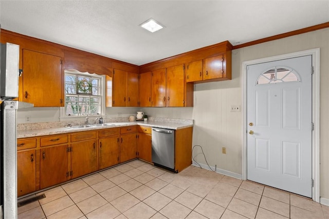 kitchen featuring visible vents, dishwasher, light countertops, brown cabinets, and a sink