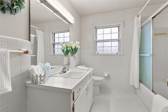 full bathroom with tile patterned floors, toilet, tile walls, and shower / bath combination with curtain