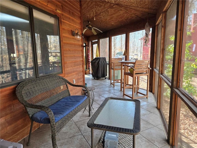 sunroom featuring a wealth of natural light and a ceiling fan