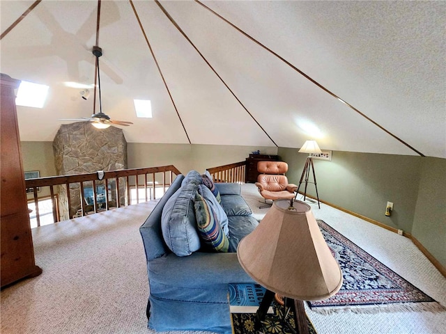 living area featuring baseboards, carpet floors, lofted ceiling, and ceiling fan