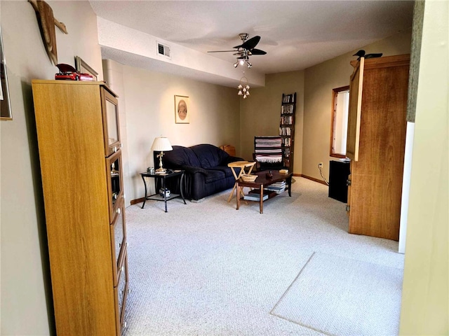 carpeted living area with a ceiling fan, visible vents, and baseboards