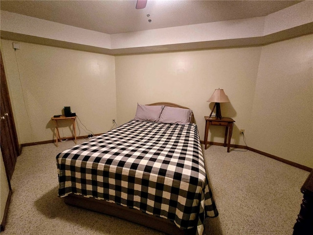 bedroom with baseboards, a ceiling fan, and carpet flooring