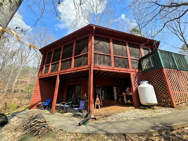 back of house featuring a patio and a sunroom