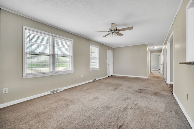 unfurnished living room featuring baseboards, visible vents, ceiling fan, a textured ceiling, and carpet flooring