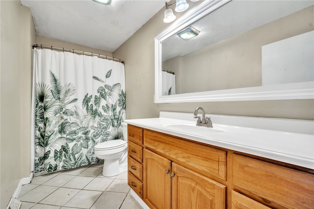 bathroom with tile patterned floors, curtained shower, toilet, and vanity