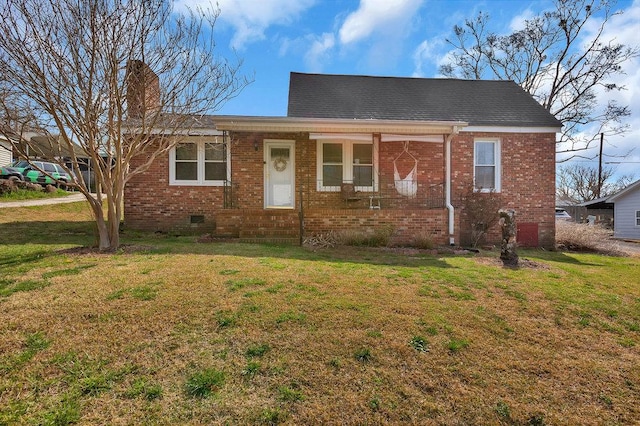 view of front of property featuring brick siding, crawl space, a chimney, and a front yard