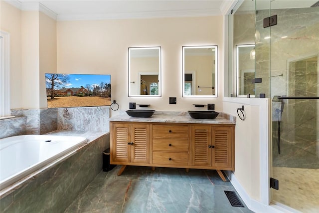 full bathroom featuring a sink, a shower stall, a bath, and crown molding