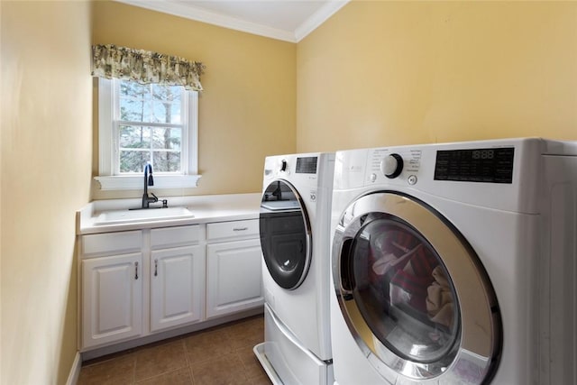 clothes washing area with tile patterned floors, independent washer and dryer, ornamental molding, and a sink