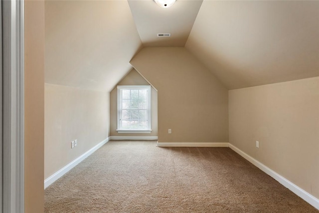 bonus room featuring vaulted ceiling, visible vents, baseboards, and carpet floors