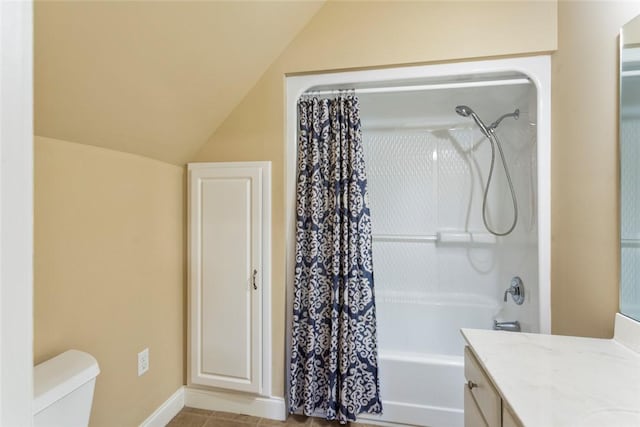 bathroom featuring tile patterned floors, toilet, shower / bath combo, lofted ceiling, and vanity