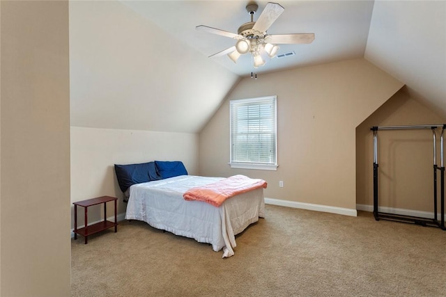 carpeted bedroom with vaulted ceiling, a ceiling fan, baseboards, and visible vents