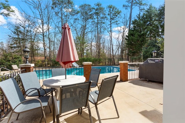 view of patio / terrace featuring area for grilling, a fenced in pool, outdoor dining area, and fence