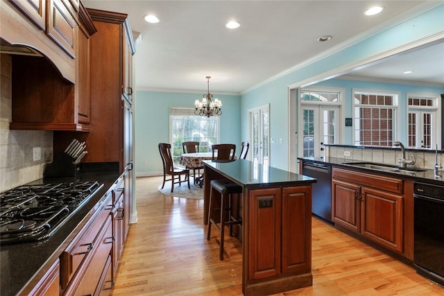 kitchen with black gas stovetop, a sink, dark countertops, french doors, and dishwasher