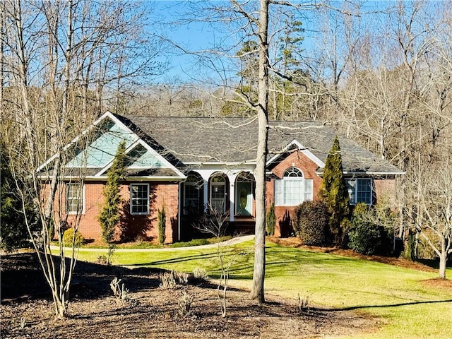 ranch-style home with brick siding and a front yard